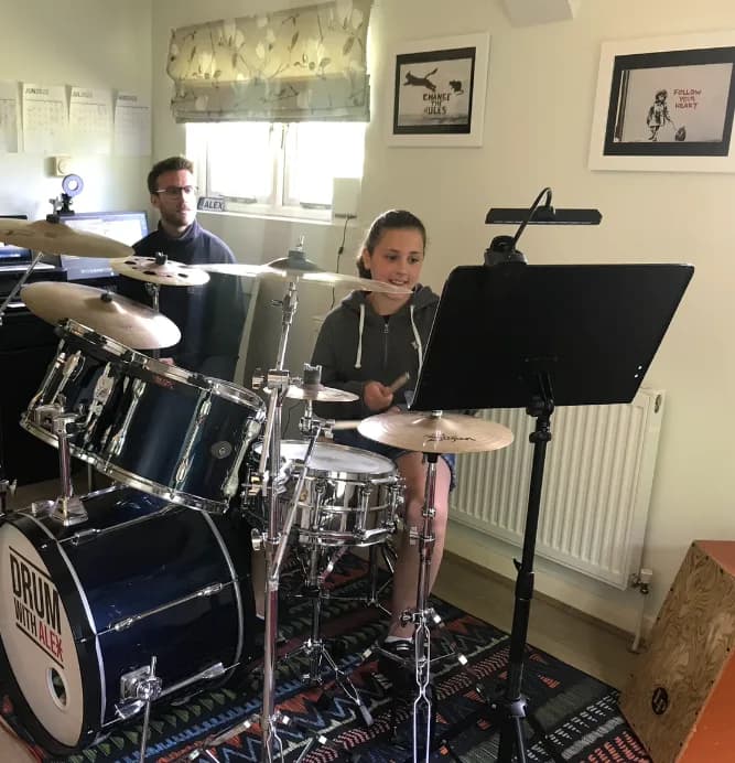 Alex Lewis teaching a private drum student.