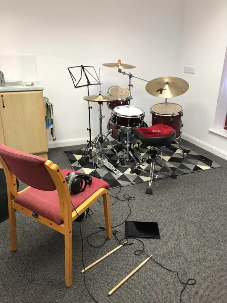 Drum kit with headphones and sticks set up at Woolton Hill Church Hall for drum lessons