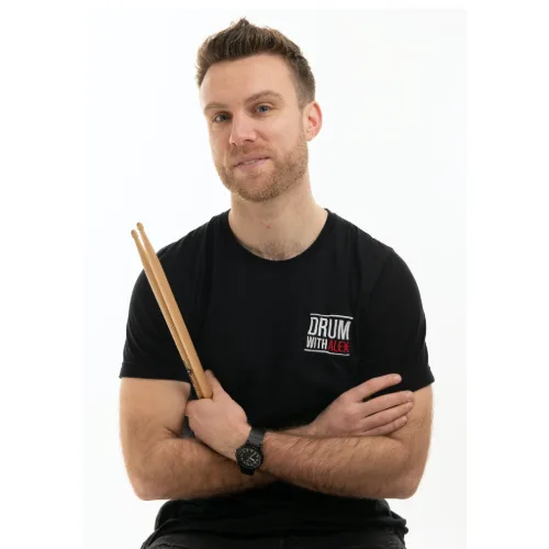 Alex holding drumsticks, ready for practice or a lesson.