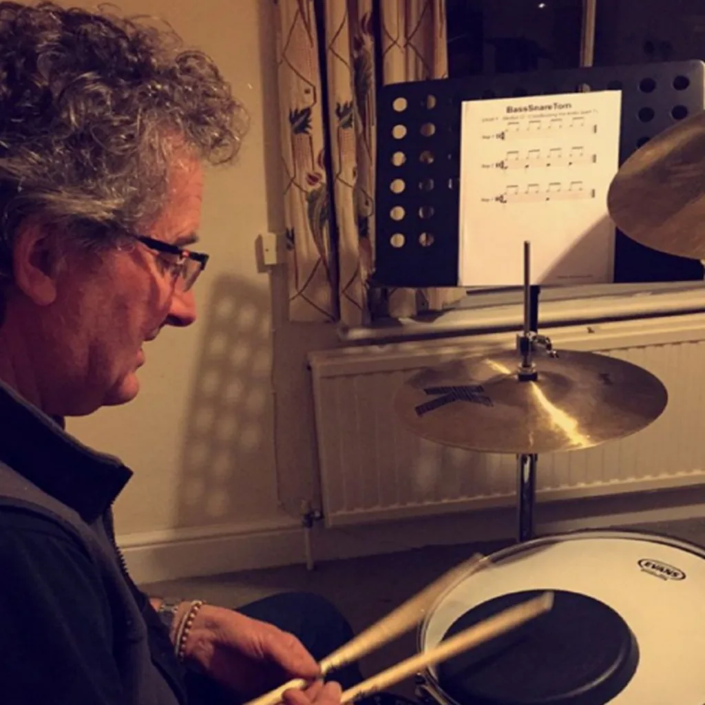 Drum lessons gift for a mature student learning drums in a lesson