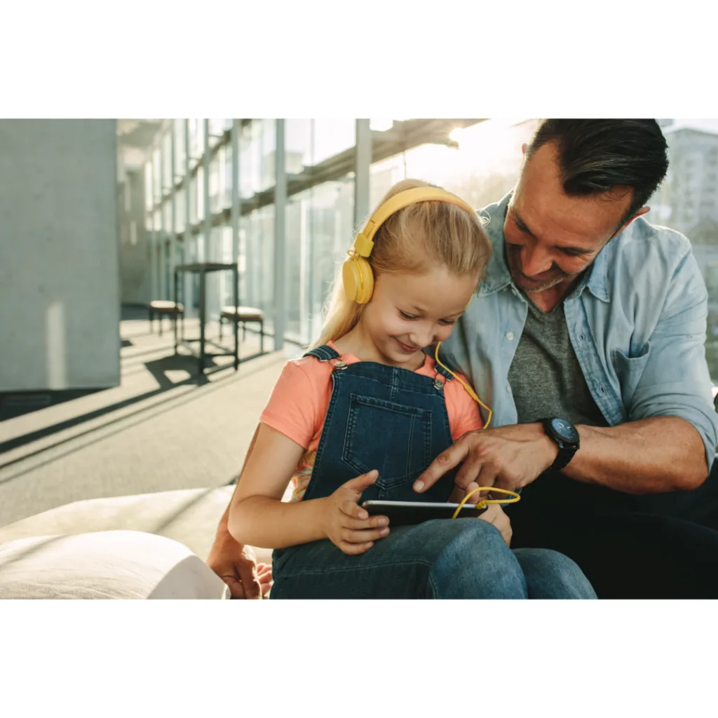 Parent and child watching inspirational music videos together on a tablet.