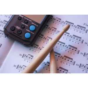Drummer using a metronome to practice rhythm.